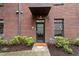 Close up of the front door of a brick condo with landscaping at 1300 Dekalb Ne Ave # 711, Atlanta, GA 30307