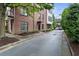 Brick condo building with black framed windows and mature landscaping at 1300 Dekalb Ne Ave # 711, Atlanta, GA 30307