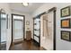 Hallway featuring dark hardwood floors, a decorative door, and access to the bathroom at 1300 Dekalb Ne Ave # 711, Atlanta, GA 30307