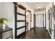 Hallway featuring a sliding glass door, dark hardwood floors, and contemporary design at 1300 Dekalb Ne Ave # 711, Atlanta, GA 30307