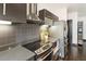 Gourmet kitchen featuring sleek appliances, grey backsplash, and eat-in counter at 1300 Dekalb Ne Ave # 711, Atlanta, GA 30307