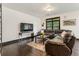 Inviting living room with large windows, leather sofa, and decorative area rug at 1300 Dekalb Ne Ave # 711, Atlanta, GA 30307