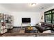 Modern living room with a leather sofa, TV, and built in shelves at 1300 Dekalb Ne Ave # 711, Atlanta, GA 30307