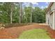 Spacious backyard with a wooden fence and a patio area perfect for entertaining at 3395 The Commons Dr, Cumming, GA 30041