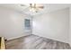 Minimalist bedroom with gray floors, a window, and a ceiling fan at 3395 The Commons Dr, Cumming, GA 30041