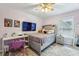 Comfortable bedroom with a ceiling fan, television, and a plush rug on the floor at 3395 The Commons Dr, Cumming, GA 30041