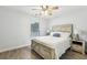 Bright bedroom featuring a farmhouse style bed frame and hardwood style floors at 3395 The Commons Dr, Cumming, GA 30041