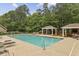 Community pool with lounge chairs and covered picnic areas at 3395 The Commons Dr, Cumming, GA 30041