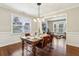 Dining room with hardwood floors and an adjacent office area, enhancing the living space at 3395 The Commons Dr, Cumming, GA 30041