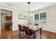 Dining area with stylish chandelier and hardwood flooring, complemented by elegant decor at 3395 The Commons Dr, Cumming, GA 30041