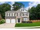 Charming two-story home features a stone facade, manicured lawn, and a two-car garage at 3395 The Commons Dr, Cumming, GA 30041