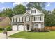 Charming two-story home with a manicured front yard, stone accents and an attached two-car garage at 3395 The Commons Dr, Cumming, GA 30041