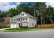 Beautifully landscaped two-story home with a stone facade, two-car garage, and pristine lawn at 3395 The Commons Dr, Cumming, GA 30041