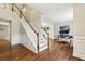 Spacious entry foyer with hardwood floors, stairs, and natural light at 3395 The Commons Dr, Cumming, GA 30041