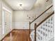 Welcoming foyer with hardwood floors, staircase, and wainscoting at 3395 The Commons Dr, Cumming, GA 30041