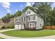 Well-maintained two-story home with stone accents, a two-car garage, and mature landscaping at 3395 The Commons Dr, Cumming, GA 30041