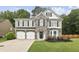 Charming two-story home with stone accents, manicured lawn, and a two-car garage at 3395 The Commons Dr, Cumming, GA 30041