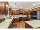 Spacious kitchen with stainless steel appliances, wooden cabinets, and a central island at 3395 The Commons Dr, Cumming, GA 30041
