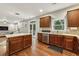 Open kitchen featuring stainless steel appliances, hardwood floors, and a view into the living area at 3395 The Commons Dr, Cumming, GA 30041