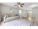 A living room that has hardwood floors, a ceiling fan, and a large sofa at 3395 The Commons Dr, Cumming, GA 30041