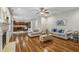 Bright living room with fireplace, hardwood floors, and open access to the modern kitchen at 3395 The Commons Dr, Cumming, GA 30041