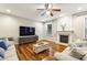 Bright living room with hardwood floors, fireplace, and modern furniture at 3395 The Commons Dr, Cumming, GA 30041