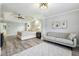 A main bedroom with a luxury ceiling, a king bed, and an adjacent seating area at 3395 The Commons Dr, Cumming, GA 30041