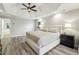 A main bedroom with luxury ceiling, a king bed, and hardwood floors at 3395 The Commons Dr, Cumming, GA 30041