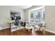 Bright home office featuring a desk, chair, and sitting area with a bay window at 3395 The Commons Dr, Cumming, GA 30041