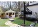 The property's backyard features a sign, gazebo, and lush landscape, enhancing the home's exterior charm and curb appeal at 4210 Gatewood Ln, Peachtree Corners, GA 30097