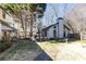 Spacious backyard features stone pathway leading to a modern home with large windows, ideal for outdoor enjoyment at 4210 Gatewood Ln, Peachtree Corners, GA 30097