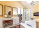 Bright primary bathroom featuring a jacuzzi tub, walk-in shower, and vanity with and sinks at 4210 Gatewood Ln, Peachtree Corners, GA 30097