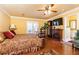 Comfortable bedroom features hardwood floors, a ceiling fan, and an ensuite bathroom at 4210 Gatewood Ln, Peachtree Corners, GA 30097