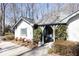 Quaint home with lovely garden, mature trees, and charming architectural details at 4210 Gatewood Ln, Peachtree Corners, GA 30097