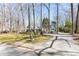 Spacious front lawn with mature trees and a paver driveway at this Tudor-style home at 4210 Gatewood Ln, Peachtree Corners, GA 30097
