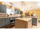 Well-equipped kitchen featuring an island, stainless steel appliances, ample cabinetry, and tiled floors at 4210 Gatewood Ln, Peachtree Corners, GA 30097