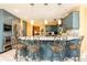 Stylish kitchen features blue cabinets, stainless appliances, a large island with barstool seating at 4210 Gatewood Ln, Peachtree Corners, GA 30097
