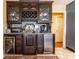 A kitchen wet bar features a beverage fridge, wine rack, granite countertops and tile floor at 4210 Gatewood Ln, Peachtree Corners, GA 30097