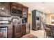 A kitchen wet bar features a beverage fridge, wine rack, granite countertops and tile floor at 4210 Gatewood Ln, Peachtree Corners, GA 30097