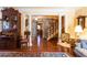 Comfortable living room featuring a stone archway, hardwood floors, and vintage furnishings at 4210 Gatewood Ln, Peachtree Corners, GA 30097