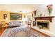 Bright living room with a white brick fireplace, large area rug, and decorative accents at 4210 Gatewood Ln, Peachtree Corners, GA 30097