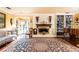 Open living room featuring a white brick fireplace, built-in shelving, and a grand piano at 4210 Gatewood Ln, Peachtree Corners, GA 30097