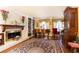 Elegant living room with a fireplace, piano, and vintage furnishings at 4210 Gatewood Ln, Peachtree Corners, GA 30097