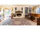 Spacious living room featuring a fireplace, built-in shelves, and hardwood floors at 4210 Gatewood Ln, Peachtree Corners, GA 30097