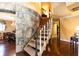 Grand staircase with hardwood floors and stone accents at 4210 Gatewood Ln, Peachtree Corners, GA 30097