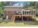 Spacious backyard with deck, sunroom, and lush landscaping, perfect for outdoor relaxation and entertaining at 4733 Eidson Road, Dunwoody, GA 30360