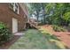 Backyard has a grassy area leading to a deck that is attached to the house, and mature trees at 4733 Eidson Road, Dunwoody, GA 30360