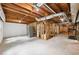 Unfinished basement with exposed beams and utilities, offering potential for customization and expansion at 4733 Eidson Road, Dunwoody, GA 30360