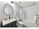 Stylish bathroom with a modern vanity, decorative mirror, and a shower-tub combination with subway tile at 4733 Eidson Road, Dunwoody, GA 30360