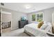Bedroom featuring plush carpeting, a large window, and soft, neutral walls, creating a cozy and inviting space at 4733 Eidson Road, Dunwoody, GA 30360